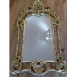 A large, gilded, Rococo-style wall mirror