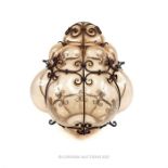 An ornate moulded blown, pink glass hanging light shade, with a wrought iron frame