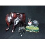 Two ebony elephants and a painted, cast-iron cat doorstop