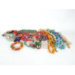 An assortment of costume jewellery to include semi-precious bead necklaces