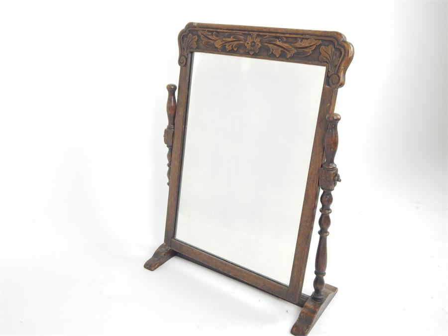 An early 20th century, hand-carved, swing-framed dressing table mirror