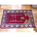A Mehrab rug, having a red field surrounded by one frieze and two running borders, 152 x 92cm.