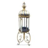 A brass framed storm lantern on stand; 109 cm high