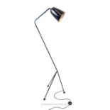 A retro, Italian, tall, black-enamelled standard lamp on tri-pod base