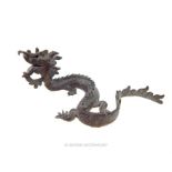 A bronzed metal Chinese dragon; 16cm long.