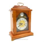 A walnut-cased, reproduction, mantle-clock