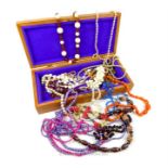 A collection of costume jewellery together with long wooden jewellery box.