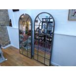 A pair of distressed bronze effect framed garden mirrors; 159 cm high