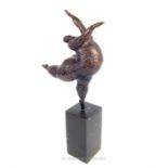 A Botero style bronze of a dancing lady, raised on a square section base