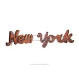 A vintage style wall mounted distressed metal New York sign
