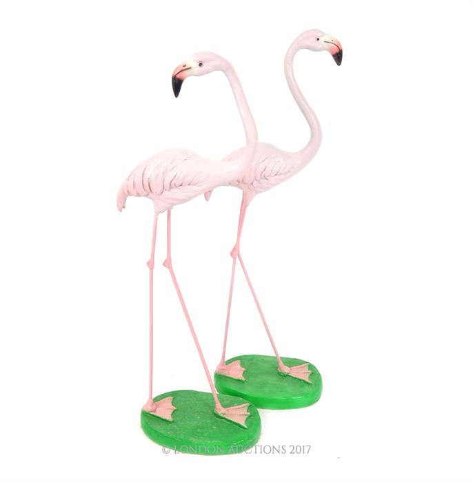 A pair of roughly life-size painted resin figures of flamingos