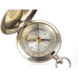 A vintage white metal cased pocket compass