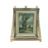 A mid 20th century landscape scene of a windswept tree against a cloudy sky; unsigned oil on