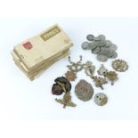 A mixed lot to include a variety of regiment badges, old postcards and coins