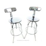 A pair chrome bar stools with swivel seets