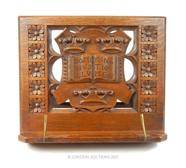 An Edwardian carved oak book rest