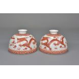 A pair of Chinese iron red dragon water pots