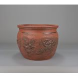 A Japanese red pottery dragon design flower pot