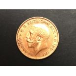 A George V 1911 half gold sovereign.