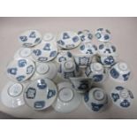 Japan eggshell porcelain cups, saucers and lids with blue white decoration with text 'A person who
