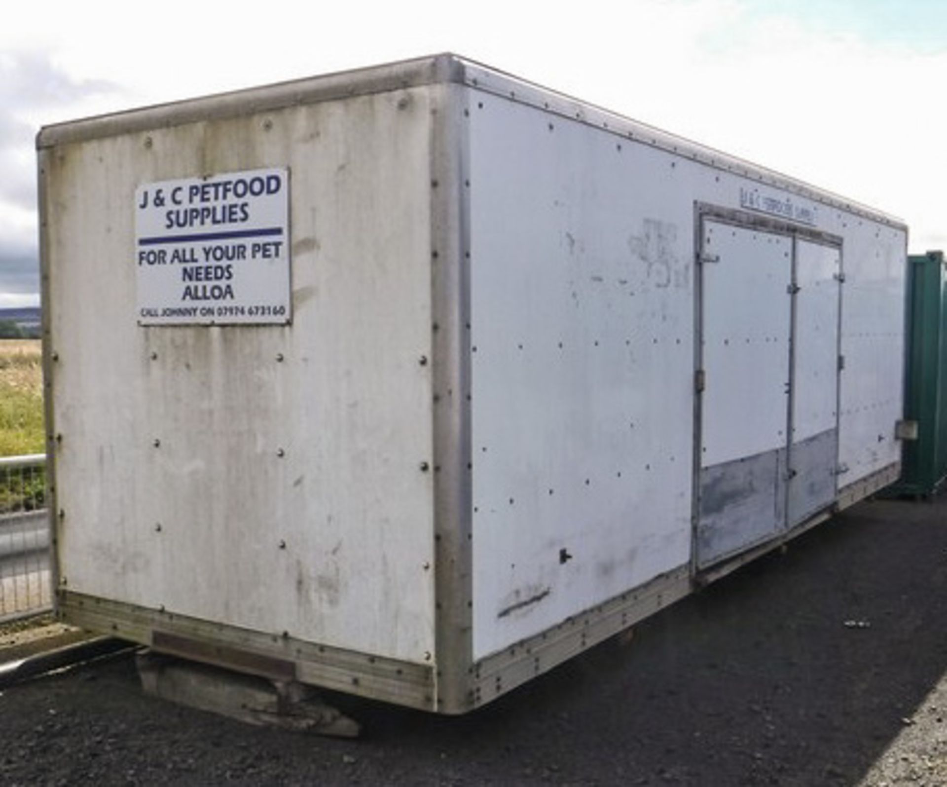 20FT x 8FT LORRY BODY C/W SHELVES & LOCKABLE SIDE DOORS. KEYS IN OFFICE