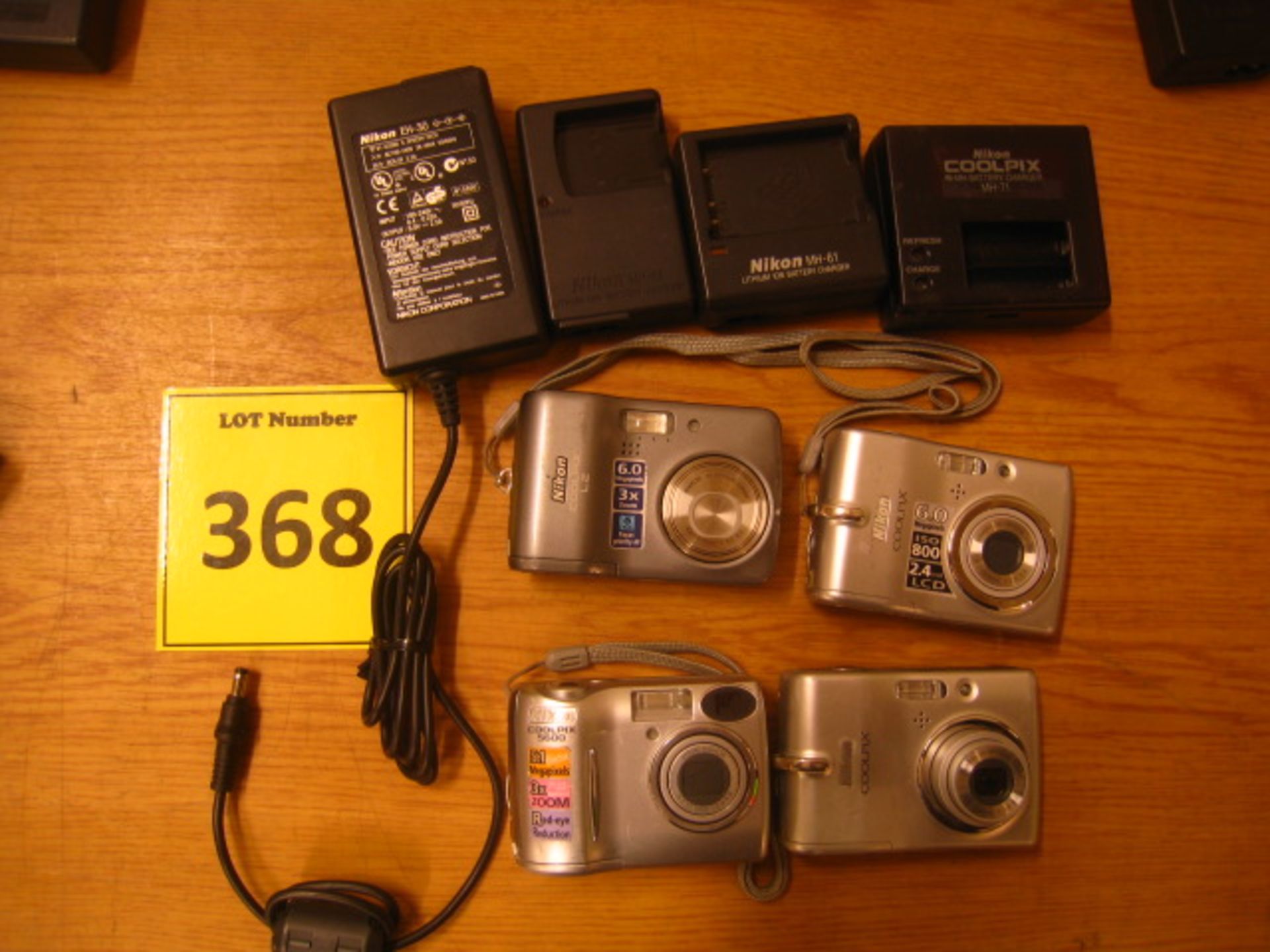 Nikon. 4 x Nikon digital cameras and 4 assorted Nikon battery charges. All untested.