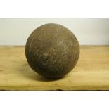 MILITARIA - An antique cast iron cannonball, measu