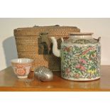 COLLECTABLES - An antique Oriental/ Chinese tea pot, cup & strainer in a cane/ wicker carry case.