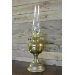 COLLECTABLES - An antique brass oil lamp with orig