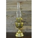 COLLECTABLES - An antique brass oil lamp with orig