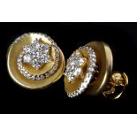 A pair of 18ct yellow gold and diamond earclips signed Damas, the bloomed swirl design set to the