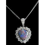 A fine black opal and diamond pendant, the heart shaped black opal showing a good display of reds,