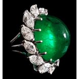 A fine 1950's Columbian emerald and diamond cluster ring, the oval cabouchon emerald of good