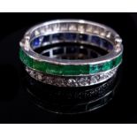 An Art Deco diamond, emerald and sapphire triple hoop 'day and night' swivel ring, mounted in