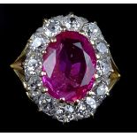 A unheated Burmese ruby and diamond cluster ring, c1910, the oval shaped mixed cut ruby weighing 3.