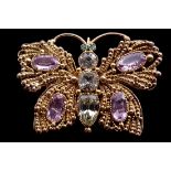 An early 19thC pink topaz, emerald, chrysolite and gold cannetille butterfly brooch, c1820, the