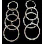 A striking pair of graduated diamond circle 18ct white gold ear pendants, c1980, each earring