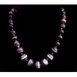 An unusual antique banded agate bead necklace, c1870, composed of forty six graduated finely