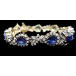 A sapphire and diamond bracelet, the central rectangular sapphire flanked by graduated pear shaped