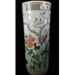 A Chinese porcelain stick stand, cylindrical, painted in famille rose colours with birds amid