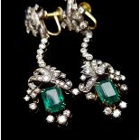 A pair of emerald and diamond screw drop earrings, the emerald set beneath foliate scroll pendants