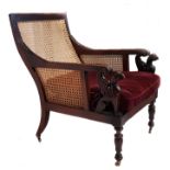 A unusual pair of 19thC carved walnut bergere armchairs, probably c1830, the shaped chairs with