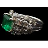 An emerald and diamond ring, the 2.00ct stone set in three rows of scattered brilliant and bagette