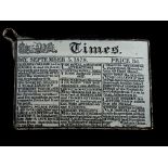 An English enamel on white metal watch fob, decorated in miniature type as a page from the Times