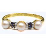 An 18ct yellow gold flexible bangle set with three pink pearls interspersed with bands of blue