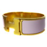 Vintage Costume Jewellery - A Hermes clic clac pink enamel bracelet on yellow metal finish,