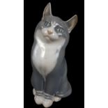 A Nielson for Royal Copenhagen Porcelain - a figure of a cat, grey and white bib and feet, shape