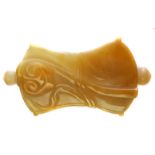 A carved yellow jade snuff bottle, carved with a lotus flower and a musical bamboo, waisted