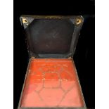 A Chinese lacquer box, square, decorated with gilded figures and a black ground, red interior to