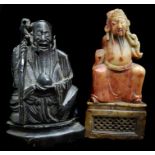 Two Chinese soapstone figures of Immortals; one variegated orange brown; the other dark brown